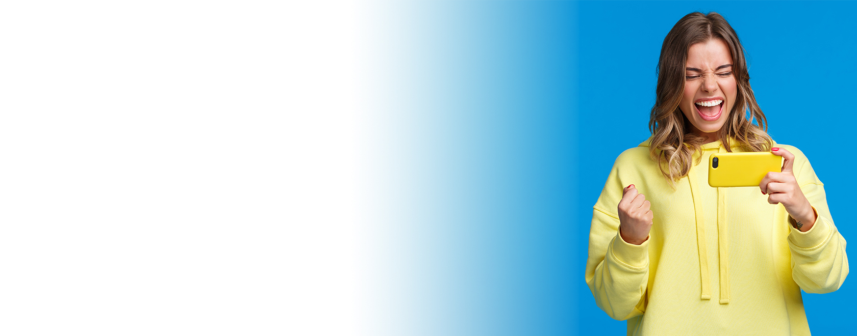 Woman looks excitedly at phone